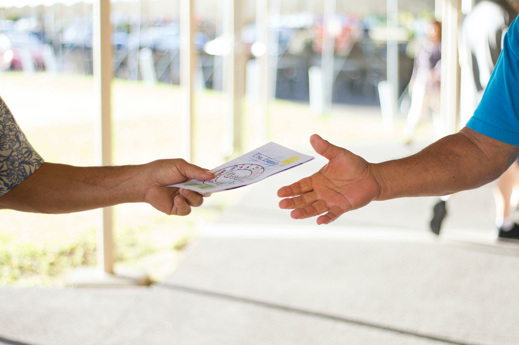 Person handing a leaflet